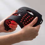 Hands bending the soft flexible silicone LED mask